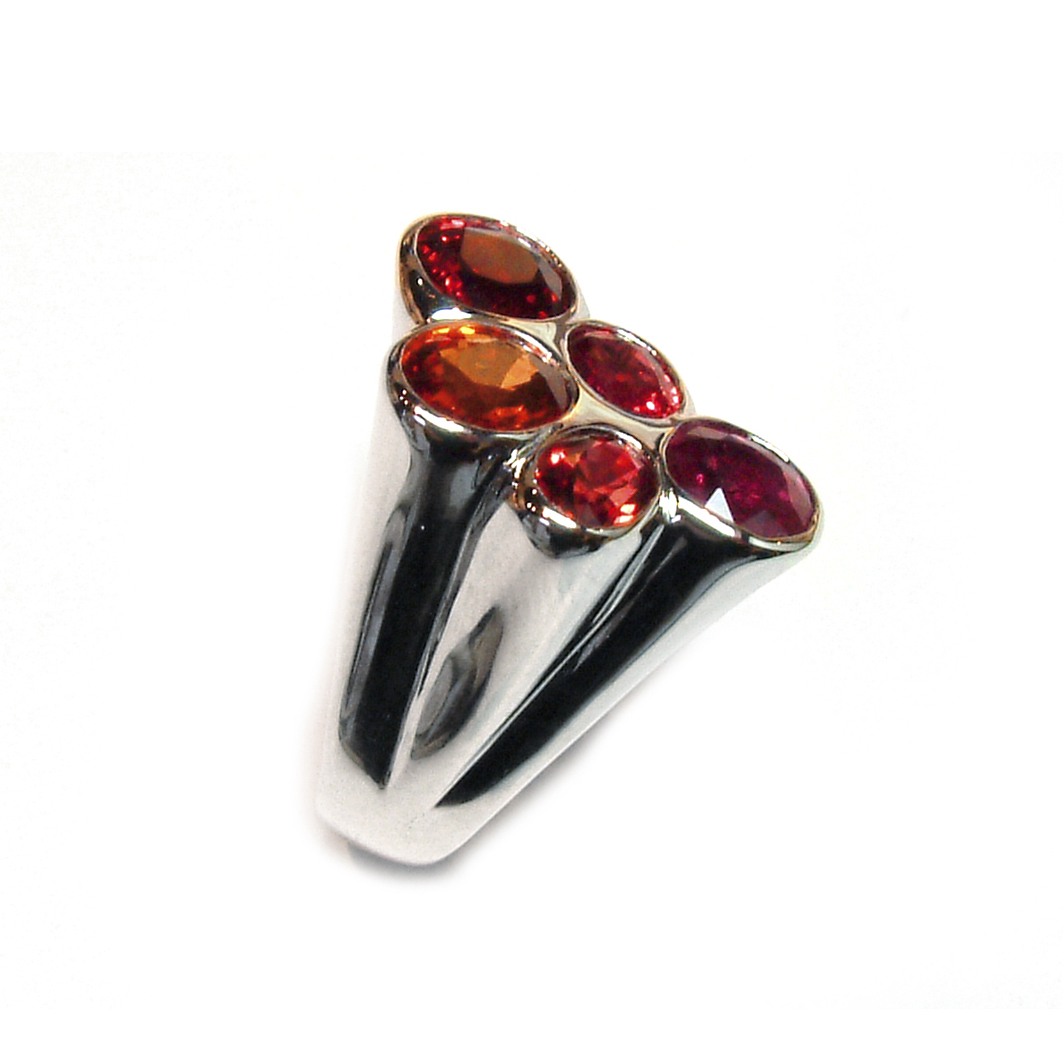 Contemporary exuberant ring set with orange sapphires